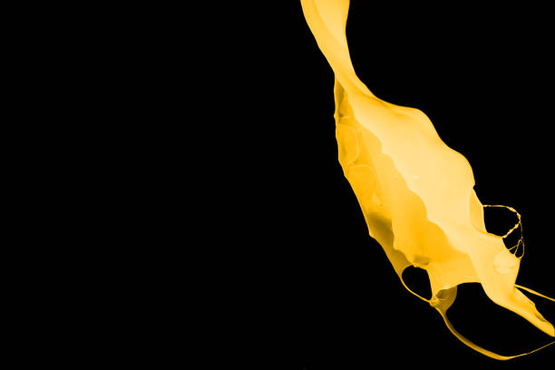 istock Yellow paint splash isolated on black background. 1079764508