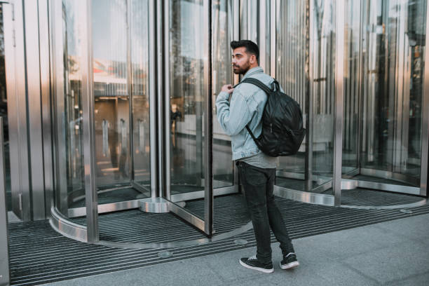Young man entering an office building
