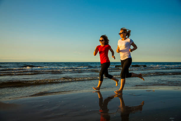 istock Two women running on beach 1079778642