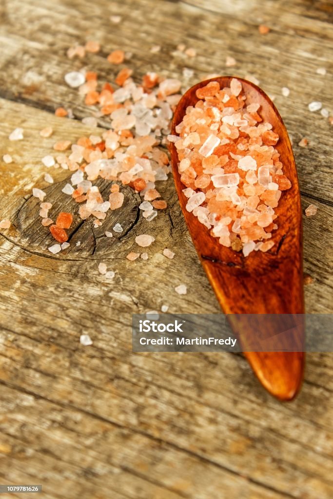 Pink salt from the Himalayas on wooden background. Pile of pink Himalayan salt. Sale of spices Pink salt from the Himalayas on wooden background. Pile of pink Himalayan salt. Sale of spices. Alternative Lifestyle Stock Photo