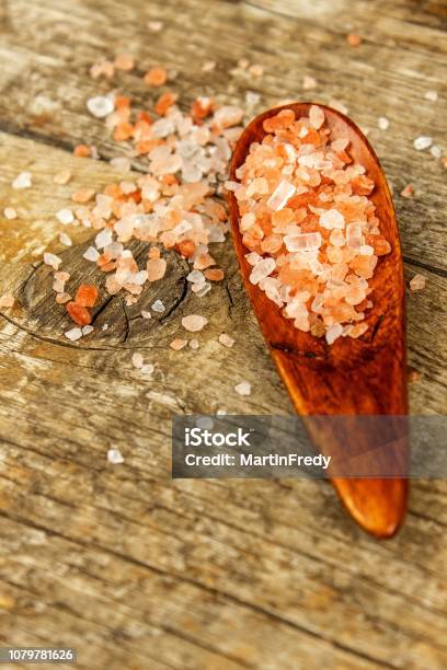 Pink Salt From The Himalayas On Wooden Background Pile Of Pink Himalayan Salt Sale Of Spices Stock Photo - Download Image Now
