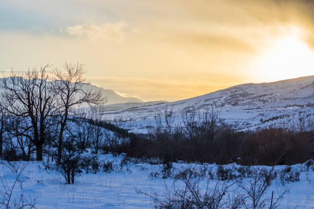 istock Bright golden sunset and the snowy mountains 1079785694