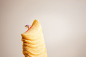 Miniature skier sliding down the stack of potato chips