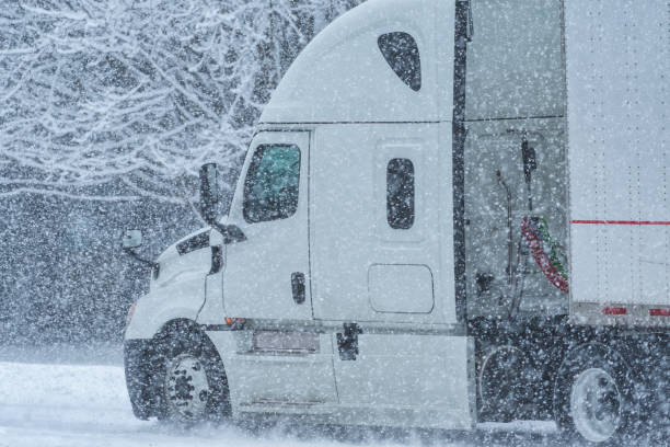 istock A semi tractor trailer on a country road during a snow storm 1079794494