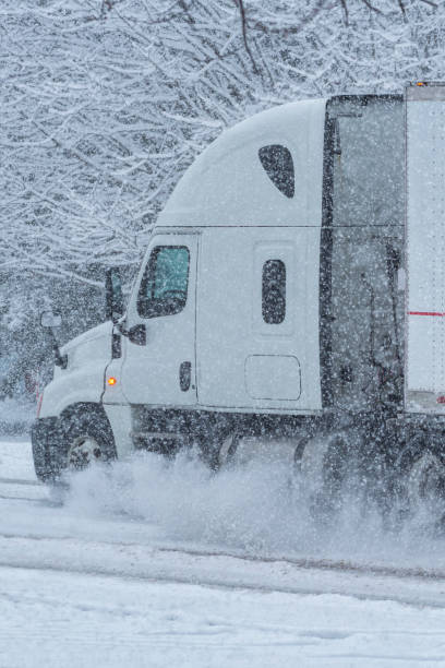 istock A semi tractor trailer on a country road during a snow storm 1079794672