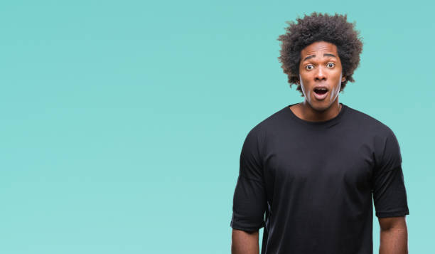 istock Afro american man over isolated background afraid and shocked with surprise expression, fear and excited face. 1079800238