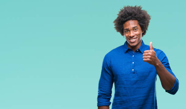 istock Afro american man over isolated background doing happy thumbs up gesture with hand. Approving expression looking at the camera with showing success. 1079800360