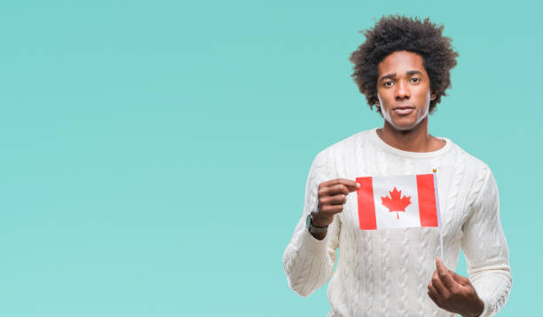 istock Afro american man flag of Canada over isolated background with a confident expression on smart face thinking serious 1079800462
