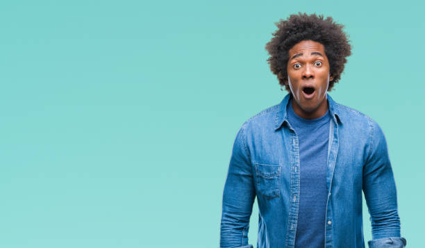 istock Afro american man over isolated background afraid and shocked with surprise expression, fear and excited face. 1079800594