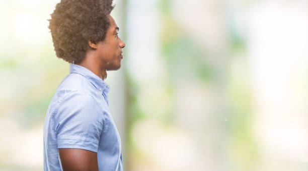 istock Afro american man over isolated background looking to side, relax profile pose with natural face with confident smile. 1079802100