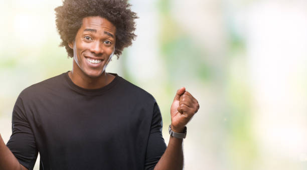istock Afro american man over isolated background celebrating surprised and amazed for success with arms raised and open eyes. Winner concept. 1079802468