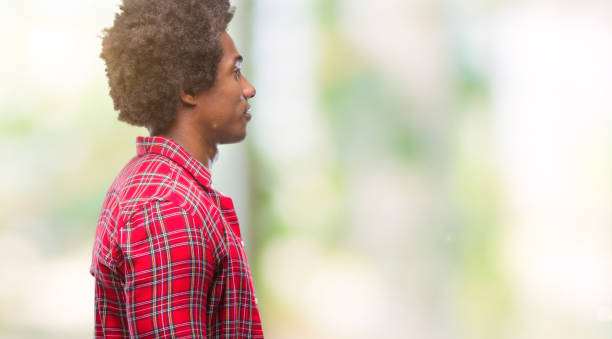 istock Afro american man over isolated background looking to side, relax profile pose with natural face with confident smile. 1079802740