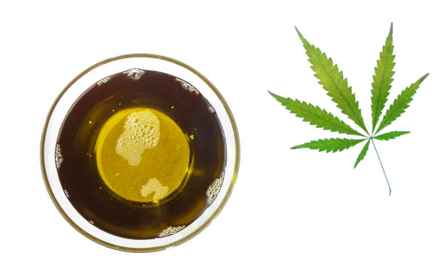 hemp oil in a glass bowl and cannabis leaf. isolated on a white background - hemp seed heap white imagens e fotografias de stock