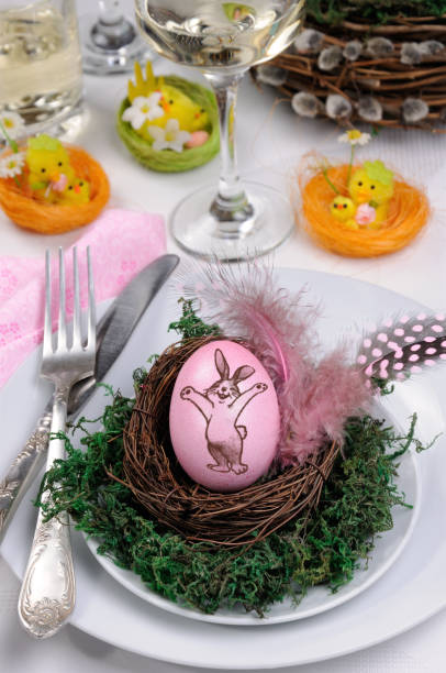 istock Egg with a rabbit stamp in a nest on a moss, like the decor of a table setting for Easter 1079819116