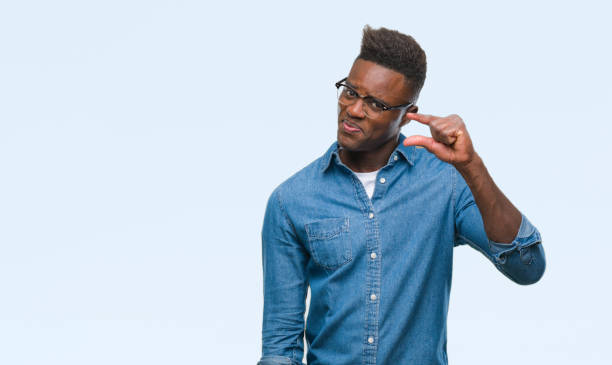 istock Young african american man over isolated background smiling and confident gesturing with hand doing size sign with fingers while looking and the camera. Measure concept. 1079819134
