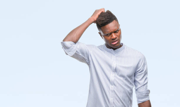 istock Young african american man over isolated background confuse and wonder about question. Uncertain with doubt, thinking with hand on head. Pensive concept. 1079819426