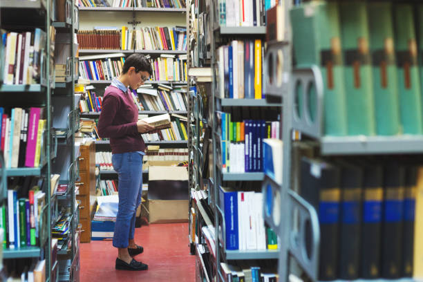 istock Young woman in the library 1079823738