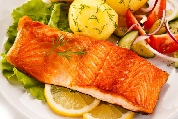 istock Grilled salmon with boiled potatoes and vegetable salad 1079824140
