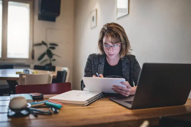 Photo of Lovely design student working at home