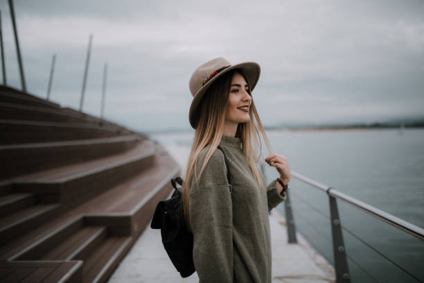 istock Young tourist wearing a hat and a backpack by the sea 1079833778