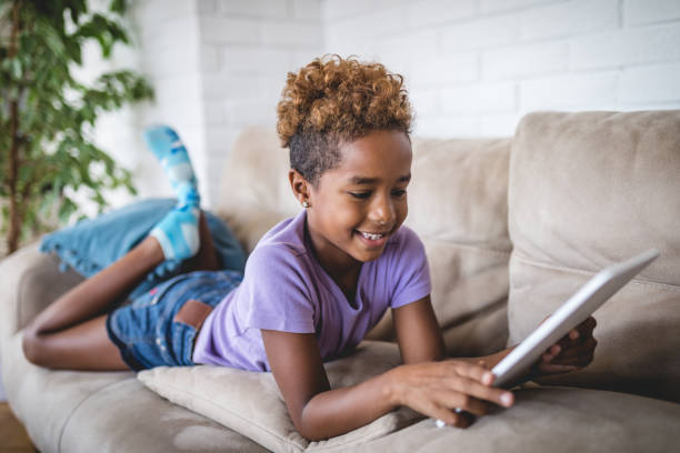 istock Cheerful child using a digital tablet at home 1079836456