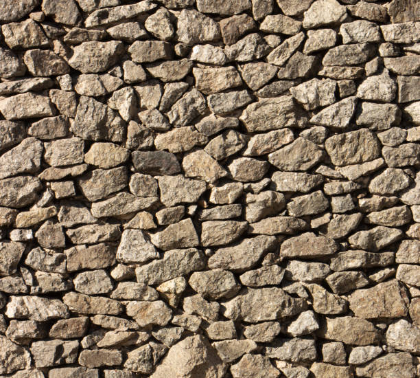 istock Dry old stone wall texture background close up 1079836766