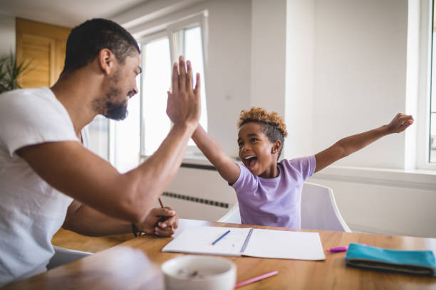 istock Cheerful family doing homework in the morning 1079837028