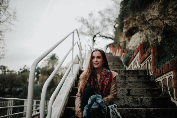 istock Young woman sitting at staircase 1079840918