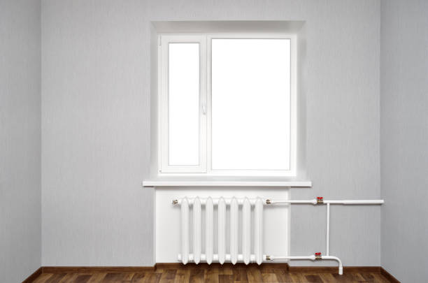 istock White window in empty room with heating and gray walls 1079851778