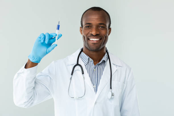 istock Positive smiling doctor holding a syringe 1079851826
