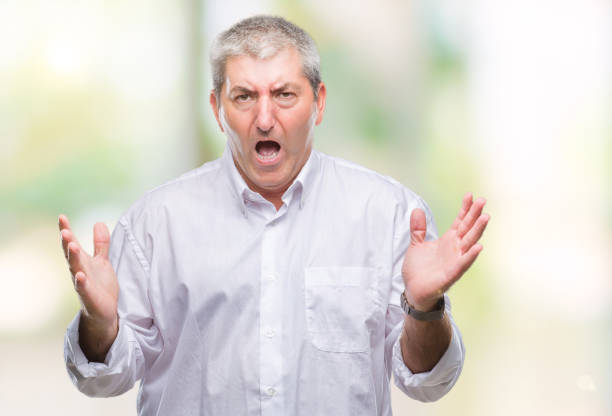 istock Handsome senior man over isolated background crazy and mad shouting and yelling with aggressive expression and arms raised. Frustration concept. 1079855698
