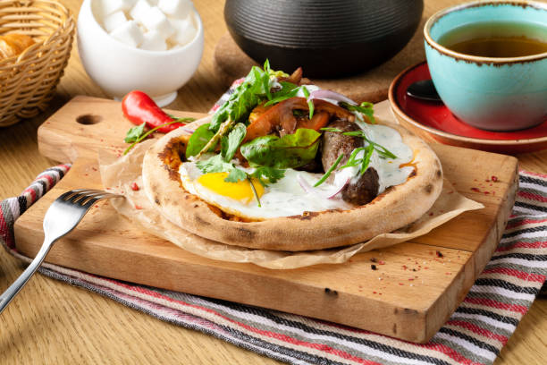 istock Breakfast set (Fried egg, Salad, Sausage smoked chicken, Ham, Bread) on wooden table 1079857282