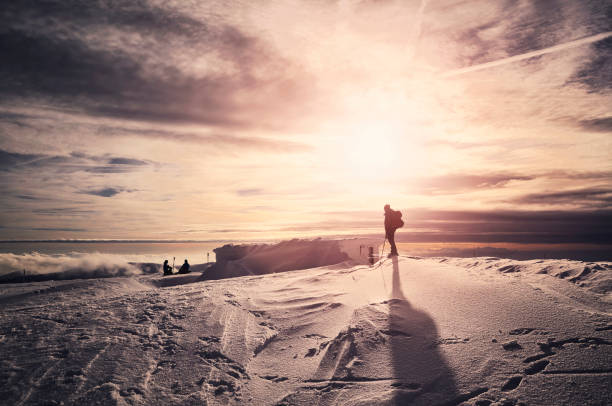 istock Winter mountains with resting skiers silhouettes at sunset. 1079871656