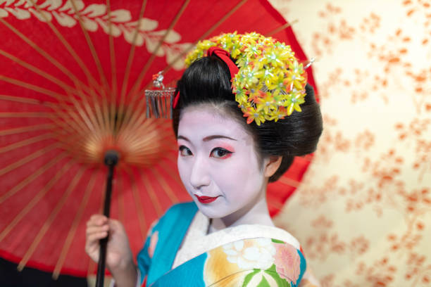 istock Maiko Apprentice Geisha holding paper umbrella 1079880398