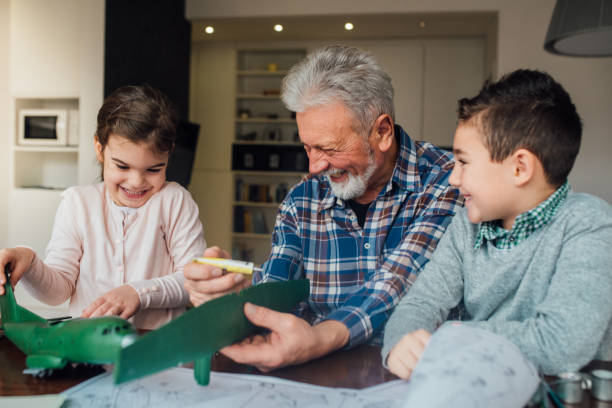 istock Happy man making toy airplane 1079885574