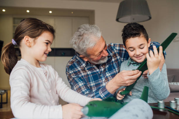 istock Children crafting a toy with grandfather 1079886092