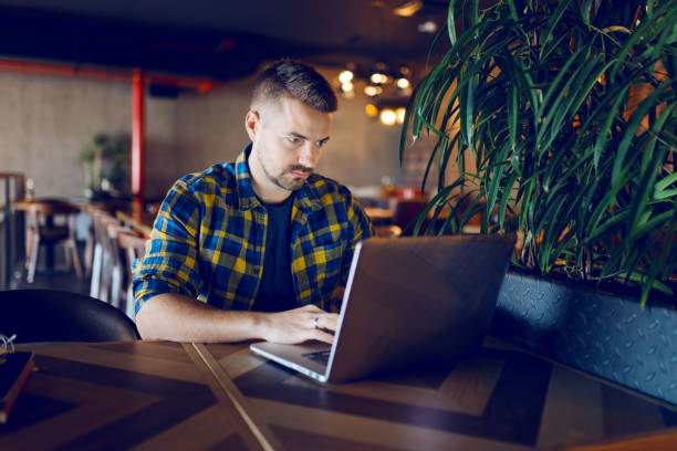 istock Caucasian freelancer working in cafeteria. Hands on keyboard. 1079892492