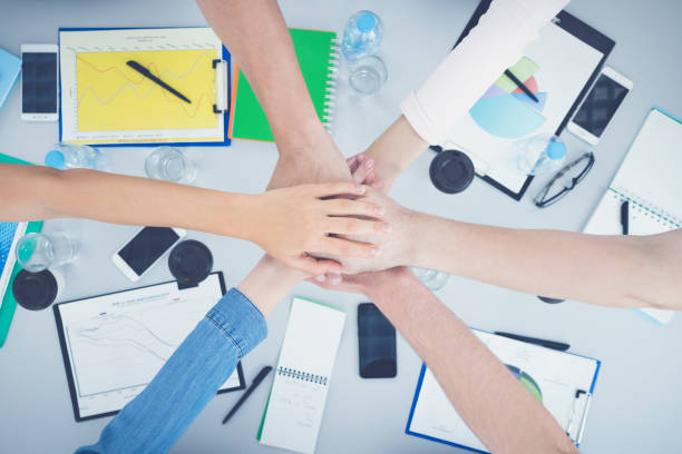 istock The students hold hands at the table. view from above 1079900574