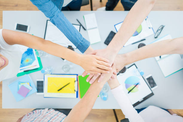 istock The six people hold hands at the desktop. view from above 1079900734