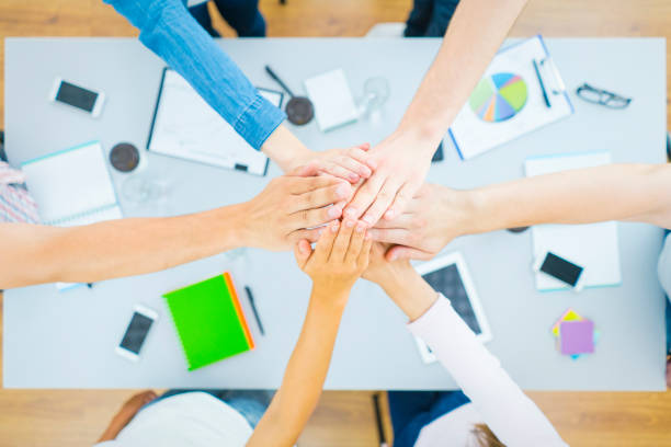 istock The six people hold hands at the desktop. view from above 1079900948