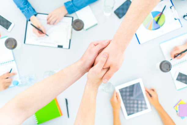 istock The people handshake at the table. view from above 1079901214