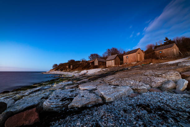 Cliffs in the foreground and fishing huts in the background