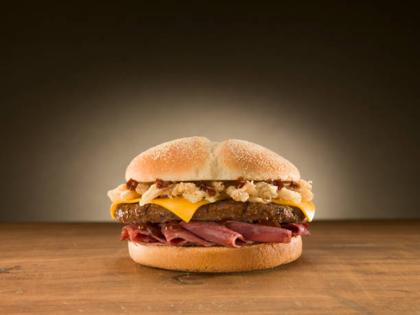 istock Cheese burger on wooden table. 1079908234