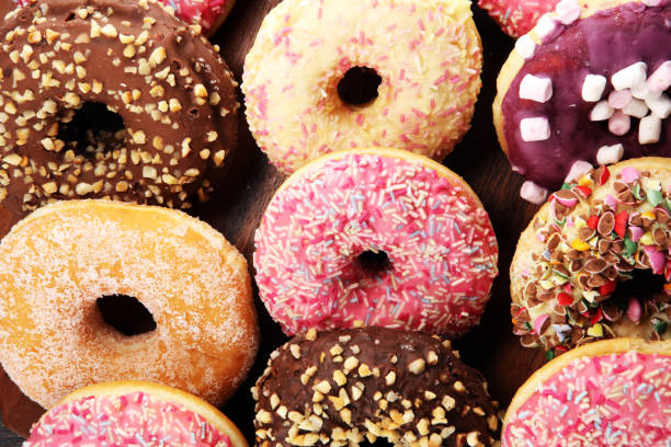 istock assorted donuts with chocolate frosted, pink glazed and sprinkles donuts 1079914304