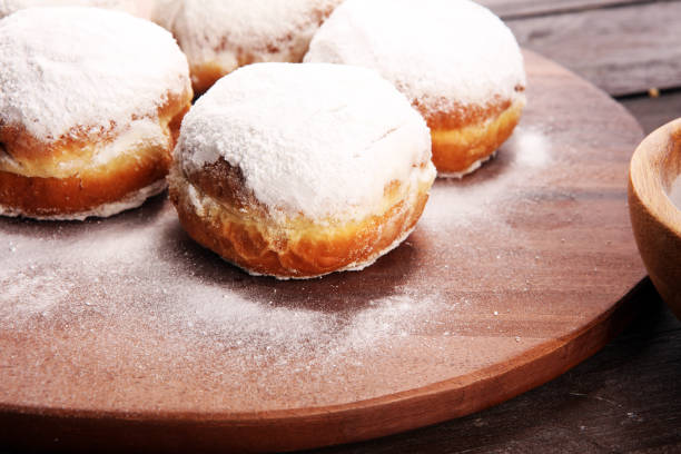 istock German donuts with jam and icing sugar. Carnival powdered sugar raised donuts 1079916320