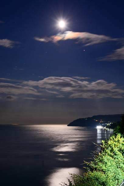 Full Moon, Clouds and Reflections Over The Bay stock photo