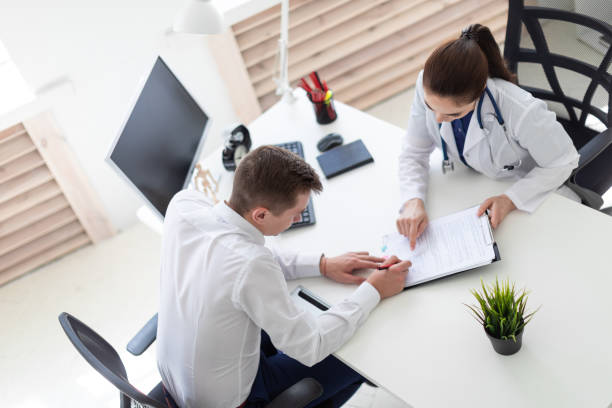 istock The young man at the doctor's office signs the documents. 1079938174
