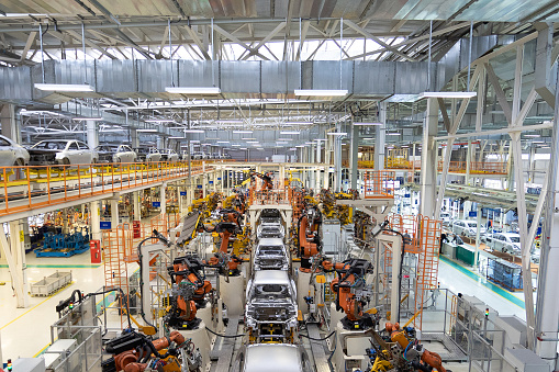 body of car on conveyor Modern Assembly of cars at plant. automated build process of car body.