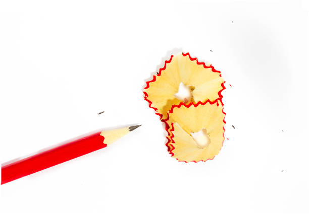 istock wooden pencil, pencil shavings and sharpener on white 1079944982