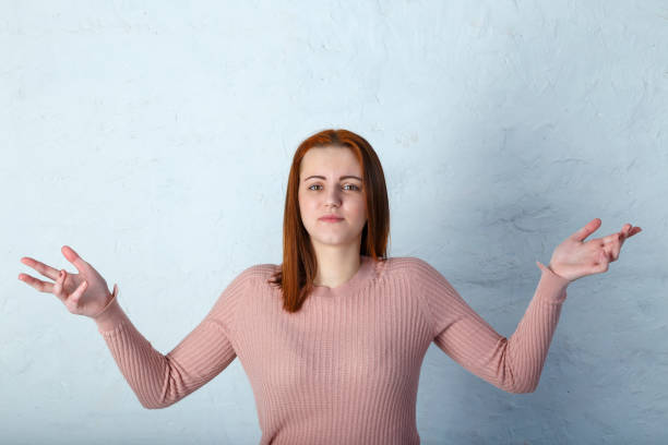istock Young Girl throws up his hands on gray background, beige toning. 1079950004
